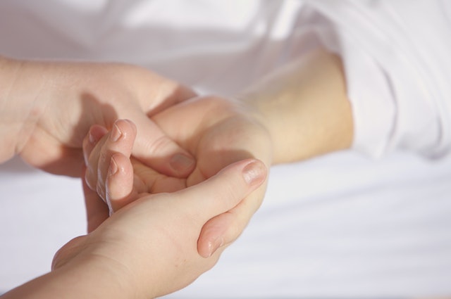 Osteopath treating hand